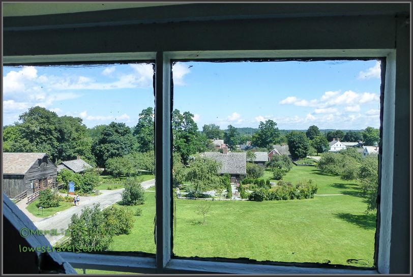 View of the collections of houses, barns, buildings viewed from a lighthouse. Shelburne Museum