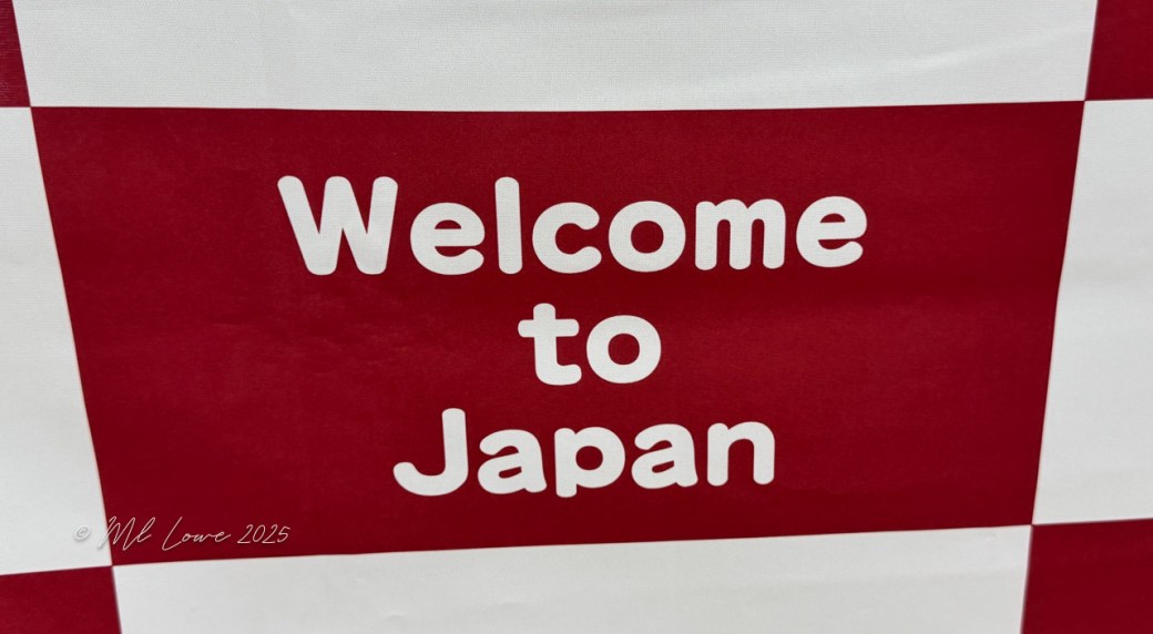 A red and white sign displaying the text 'Welcome to Japan'.
