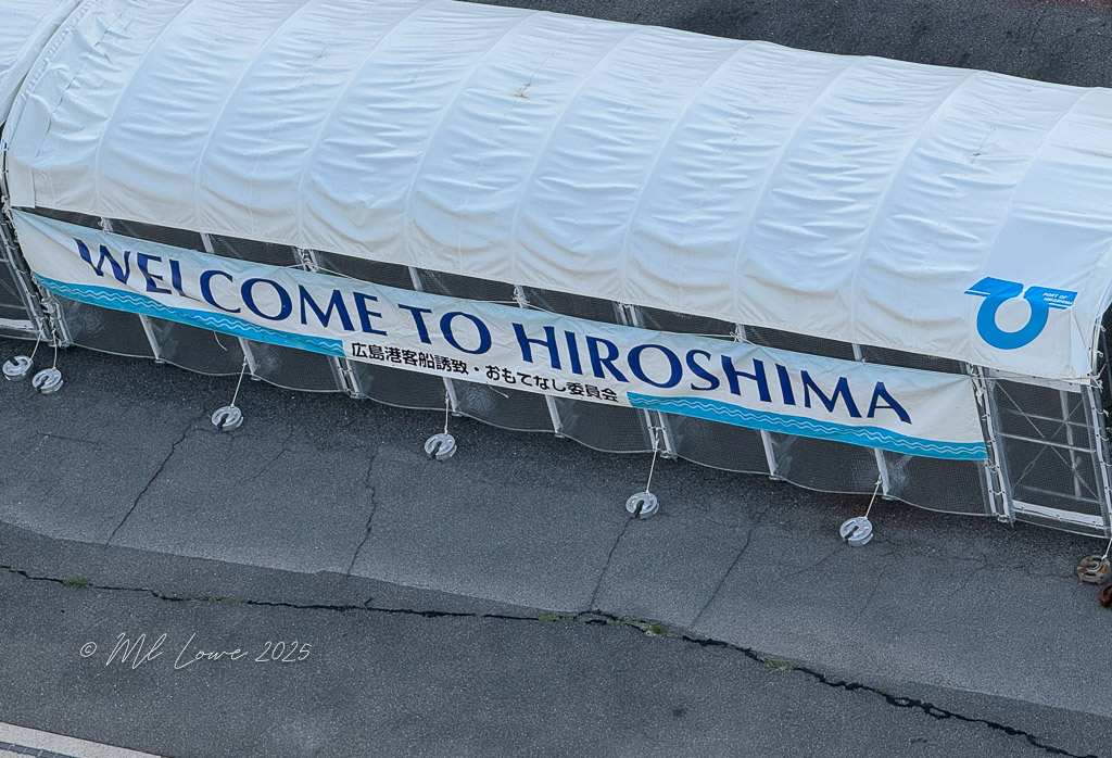 A banner reading 'WELCOME TO HIROSHIMA' displayed at the port, with the city's name prominently featured.