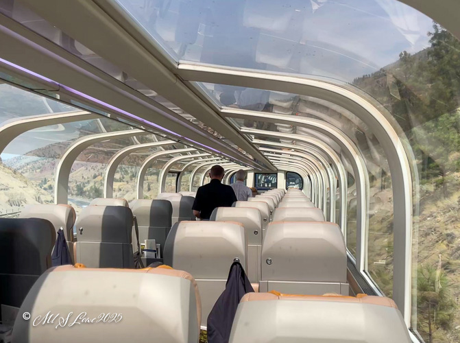 Interior view of the Rocky Mountaineer train showing spacious seating and large windows for scenic views.