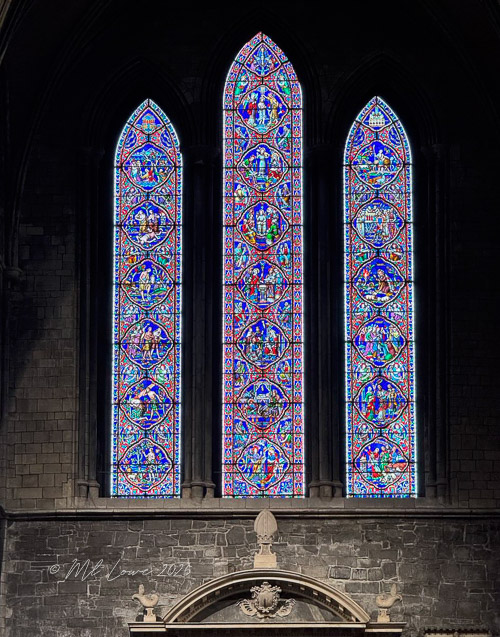 Stained glass windows of St. Patrick's Cathedral in Dublin, featuring intricate designs and vibrant colors.