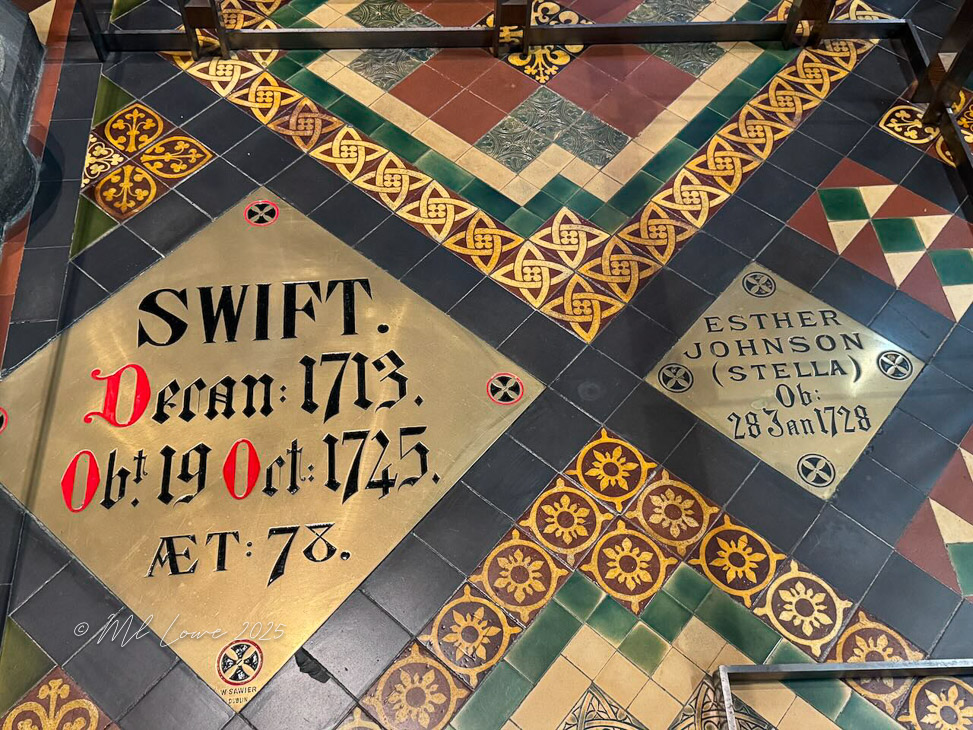 Decorative floor tiles inside St. Patrick's Cathedral featuring inscriptions commemorating Jonathan Swift and Esther Johnson.